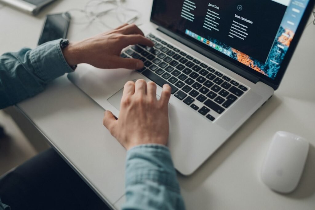 Website designer working on a laptop in a modern workspace
